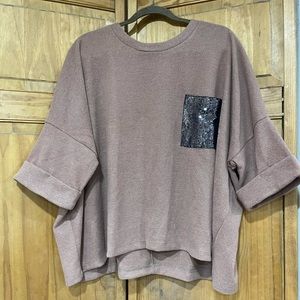 White Birch short-sleeve sweater with black sequined pocket.